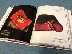An open book showing photos of WW1 artefacts